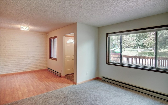 8 Sequoia Ct Unit 8, Steamboat Springs, CO 80487 - empty room with baseboard heating, a textured ceiling, light colored carpet, and baseboards