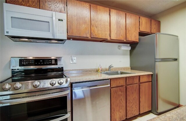8 Sequoia Ct Unit 8, Steamboat Springs, CO 80487 - kitchen featuring stainless steel appliances, light countertops, a sink, and brown cabinetry