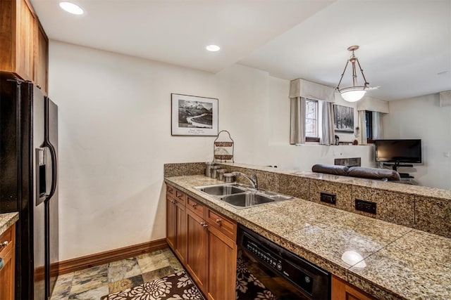 kitchen with black appliances, tile countertops, a sink, brown cabinetry, and baseboards