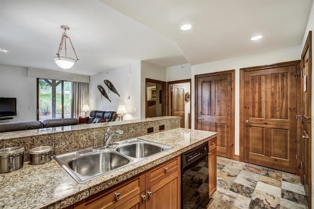 kitchen with dishwasher, open floor plan, a sink, hanging light fixtures, and light countertops