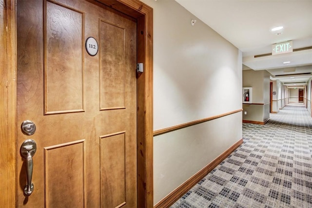 hall with carpet flooring and baseboards