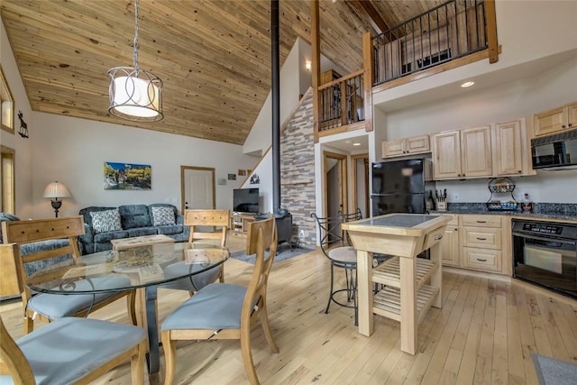 3222 Middle Fork Vis, Fairplay, CO 80440 - kitchen featuring black appliances, high vaulted ceiling, wooden ceiling, light brown cabinetry, and dark countertops