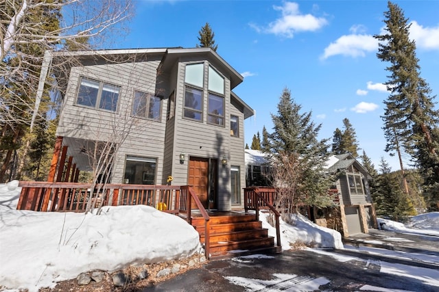 284 Lakeshore Loop, Blue River, CO 80424 - view of front of home with an attached garage and a wooden deck