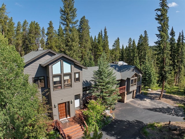 284 Lakeshore Loop, Blue River, CO 80424 - rustic home with driveway, a forest view, and a garage