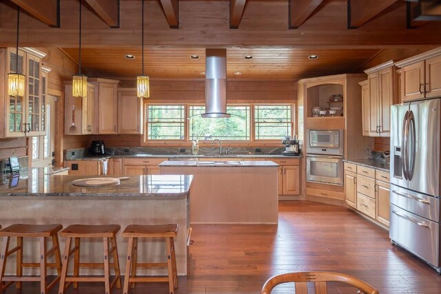 12000 Ute Pass Rd, Parshall, CO 80468 - kitchen with appliances with stainless steel finishes, wood-type flooring, wood ceiling, a peninsula, and exhaust hood