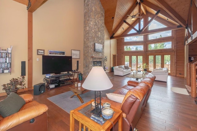12000 Ute Pass Rd, Parshall, CO 80468 - living room featuring high vaulted ceiling, wood ceiling with exposed beams, a stone fireplace, ceiling fan, and hardwood / wood-style flooring