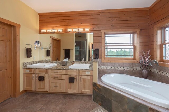 12000 Ute Pass Rd, Parshall, CO 80468 - bathroom featuring double vanity, a garden tub, and wooden walls