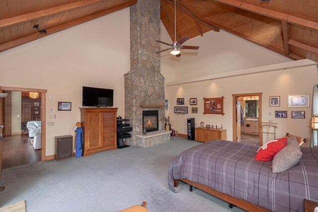 12000 Ute Pass Rd, Parshall, CO 80468 - carpeted bedroom with high vaulted ceiling, a stone fireplace, wooden ceiling with exposed beams, and baseboards