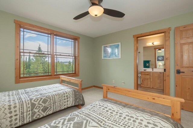 12000 Ute Pass Rd, Parshall, CO 80468 - bedroom featuring carpet flooring, baseboards, connected bathroom, and ceiling fan