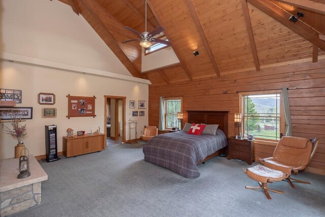 12000 Ute Pass Rd, Parshall, CO 80468 - carpeted bedroom with wood ceiling with exposed beams, multiple windows, high vaulted ceiling, and wooden walls