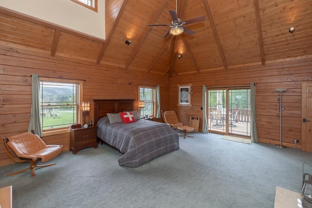 12000 Ute Pass Rd, Parshall, CO 80468 - carpeted bedroom featuring access to outside, multiple windows, wood ceiling with exposed beams, wooden walls, and high vaulted ceiling