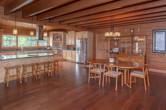 12000 Ute Pass Rd, Parshall, CO 80468 - dining space featuring beamed ceiling, wooden walls, dark wood-style floors, and a chandelier