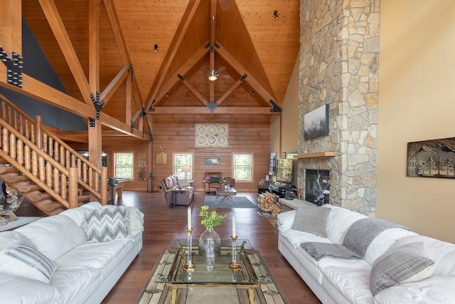 12000 Ute Pass Rd, Parshall, CO 80468 - living room featuring a fireplace, high vaulted ceiling, wood ceiling with exposed beams, stairway, and wood finished floors