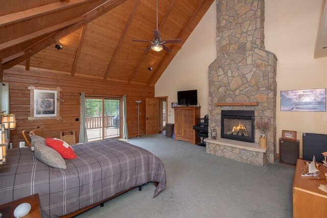12000 Ute Pass Rd, Parshall, CO 80468 - bedroom with carpet, high vaulted ceiling, wood ceiling with exposed beams, a stone fireplace, and access to outside