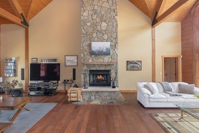 12000 Ute Pass Rd, Parshall, CO 80468 - living area with high vaulted ceiling, a stone fireplace, wood finished floors, wood ceiling with exposed beams, and baseboards