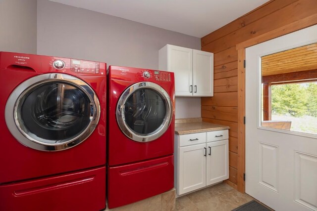12000 Ute Pass Rd, Parshall, CO 80468 - laundry room with cabinet space, independent washer and dryer, wooden walls, and light tile patterned floors