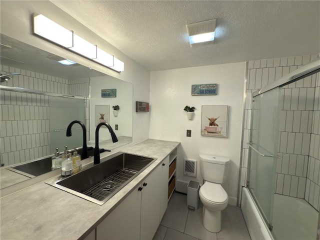 bathroom with toilet, enclosed tub / shower combo, vanity, and a textured ceiling