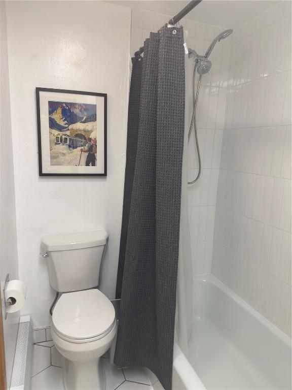 bathroom with toilet and shower / bathtub combination with curtain