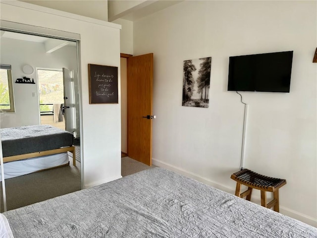 carpeted bedroom featuring baseboards