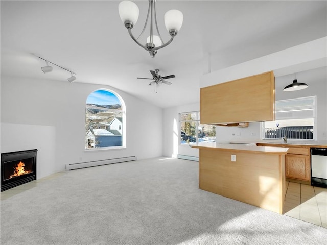 unfurnished living room with rail lighting, vaulted ceiling, baseboard heating, ceiling fan, and light colored carpet