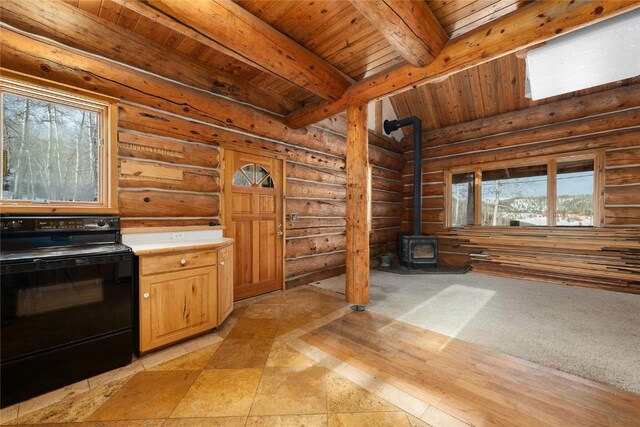 57785 Saturn Ct, Clark, CO 80428 - interior space with light countertops, electric range, beamed ceiling, wooden ceiling, and a wood stove