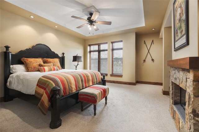 2250 Apres Ski Way Unit R105, Steamboat Springs, CO 80487 - bedroom with a stone fireplace, light colored carpet, a raised ceiling, baseboards, and recessed lighting