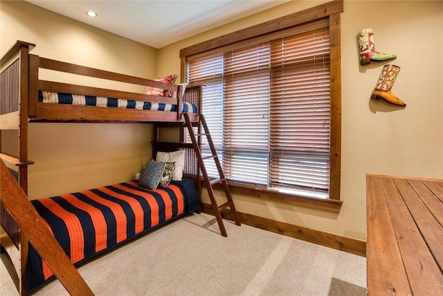 carpeted bedroom featuring baseboards and recessed lighting