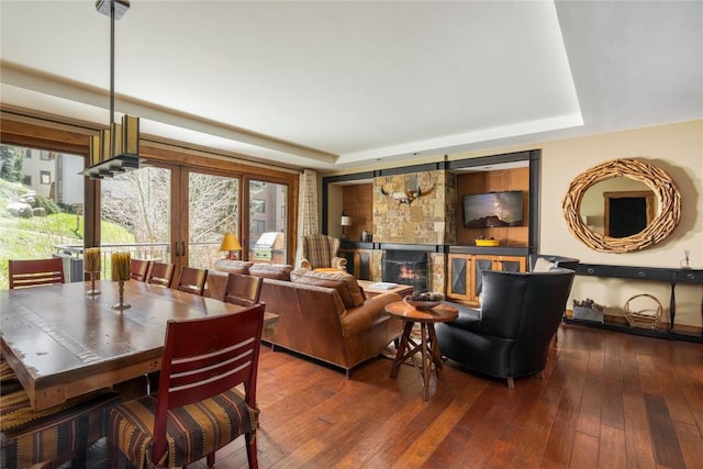 2250 Apres Ski Way Unit R105, Steamboat Springs, CO 80487 - living area featuring french doors, a tray ceiling, hardwood / wood-style flooring, and a glass covered fireplace