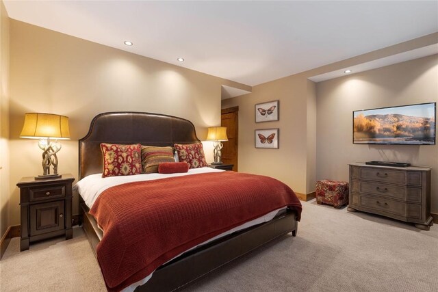 bedroom with baseboards, recessed lighting, and light colored carpet