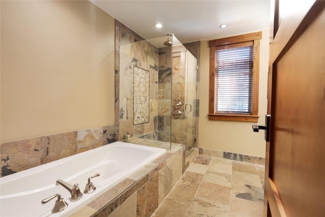 bathroom with baseboards, a stall shower, recessed lighting, and a garden tub