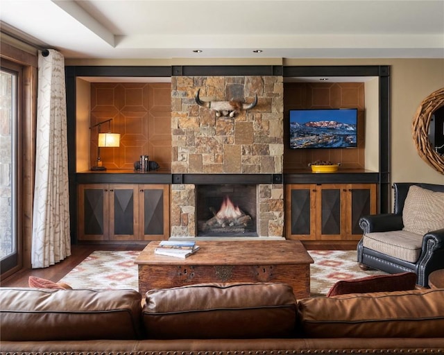 living area with a fireplace and wood finished floors