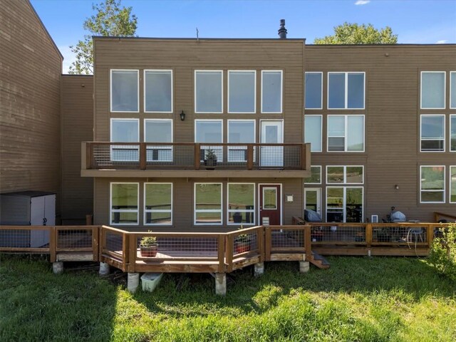 30311 County Road 16 Unit 105, Oak Creek, CO 80467 - back of house featuring a balcony and a lawn