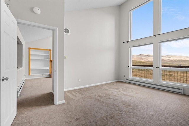 30311 County Road 16 Unit 105, Oak Creek, CO 80467 - unfurnished bedroom featuring baseboards, carpet, a towering ceiling, and baseboard heating