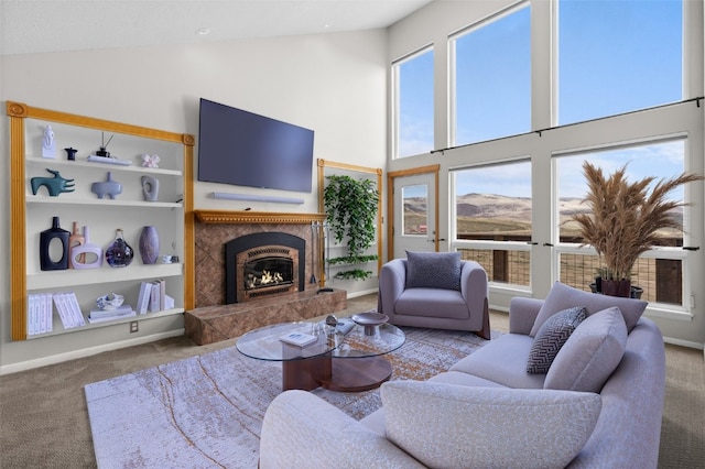 30311 County Road 16 Unit 105, Oak Creek, CO 80467 - living area with carpet floors, high vaulted ceiling, a healthy amount of sunlight, and a premium fireplace