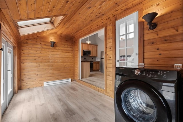 30311 County Road 16 Unit 105, Oak Creek, CO 80467 - washroom featuring washer / clothes dryer, wooden walls, wood ceiling, a baseboard heating unit, and a skylight