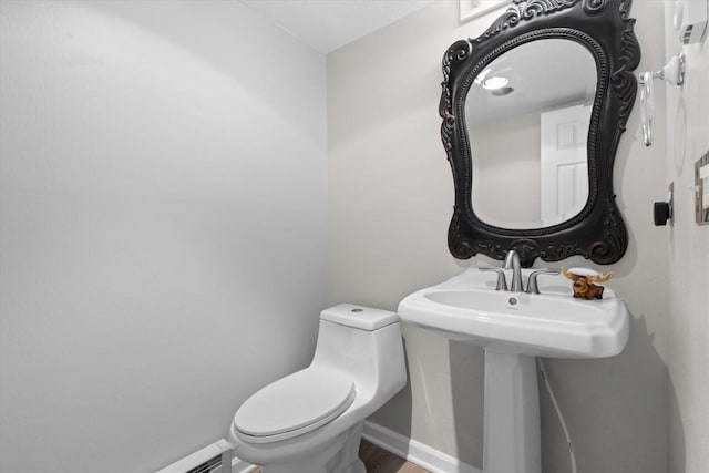 30311 County Road 16 Unit 105, Oak Creek, CO 80467 - bathroom with baseboards, a baseboard heating unit, wood finished floors, and toilet