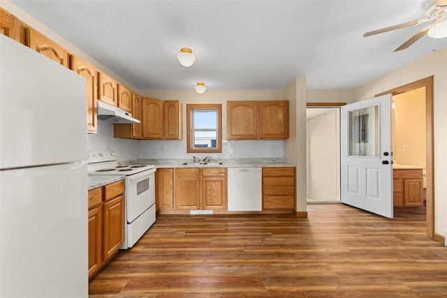 407 S 3rd St Unit 407, Hayden, CO 81639 - kitchen with white appliances, under cabinet range hood, backsplash, dark wood-type flooring, and light countertops