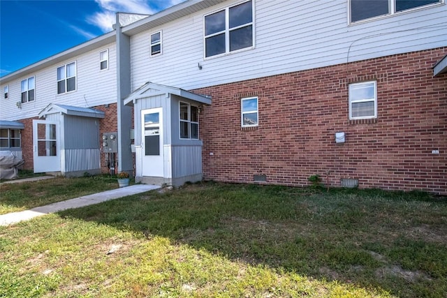 407 S 3rd St Unit 407, Hayden, CO 81639 - back of house with brick siding, a lawn, and an outdoor structure