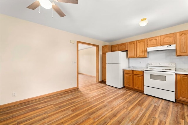 407 S 3rd St Unit 407, Hayden, CO 81639 - kitchen with white appliances, under cabinet range hood, light wood-type flooring, light countertops, and a ceiling fan