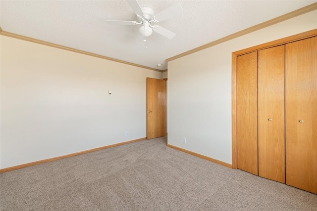 407 S 3rd St Unit 407, Hayden, CO 81639 - unfurnished bedroom featuring light carpet, ornamental molding, a closet, and a ceiling fan
