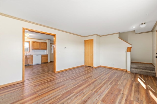 407 S 3rd St Unit 407, Hayden, CO 81639 - unfurnished living room with light wood-style floors, stairway, and crown molding