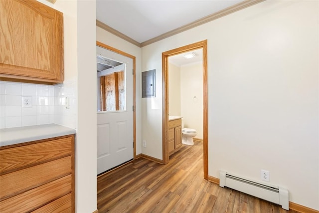 407 S 3rd St Unit 407, Hayden, CO 81639 - kitchen with a baseboard radiator, light wood-style floors, backsplash, light countertops, and electric panel