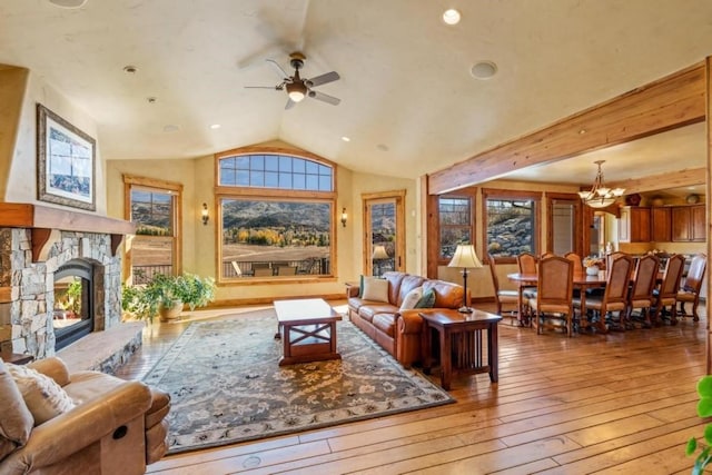 1138 Longview Cir, Steamboat Springs, CO 80487 - living room with ceiling fan, hardwood / wood-style floors, vaulted ceiling, a stone fireplace, and a chandelier