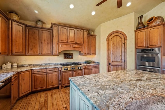 1138 Longview Cir, Steamboat Springs, CO 80487 - kitchen with stainless steel appliances, light wood finished floors, light stone countertops, a ceiling fan, and recessed lighting