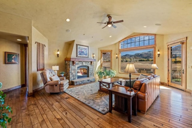 1138 Longview Cir, Steamboat Springs, CO 80487 - living area featuring vaulted ceiling, wood-type flooring, ceiling fan, a fireplace, and baseboards