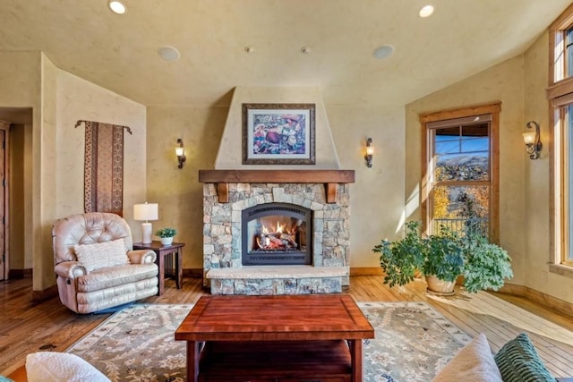 1138 Longview Cir, Steamboat Springs, CO 80487 - living room with wood finished floors, a stone fireplace, baseboards, and recessed lighting