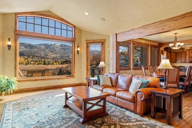 1138 Longview Cir, Steamboat Springs, CO 80487 - living room with hardwood / wood-style floors, a chandelier, vaulted ceiling, and a mountain view