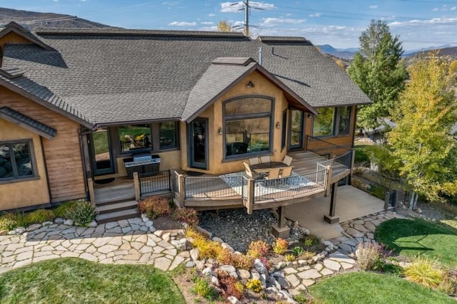 1138 Longview Cir, Steamboat Springs, CO 80487 - rear view of property with a shingled roof and a deck with mountain view