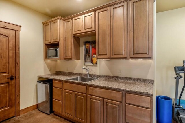 1138 Longview Cir, Steamboat Springs, CO 80487 - kitchen featuring a sink, stainless steel microwave, refrigerator, and baseboards