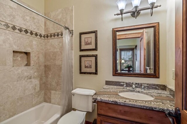 1138 Longview Cir, Steamboat Springs, CO 80487 - full bathroom with vanity, toilet, and shower / bathtub combination with curtain